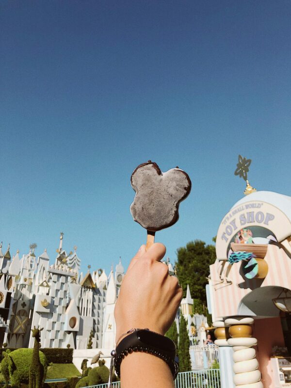 Enjoy a sunny day at Disneyland Anaheim with a tasty Mickey ice cream in hand.