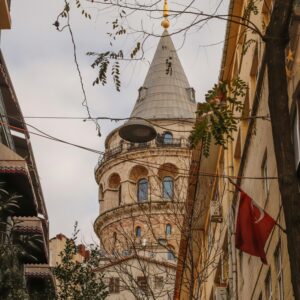 A vertical view of the iconic Galata Tower amidst Istanbul's urban architecture.