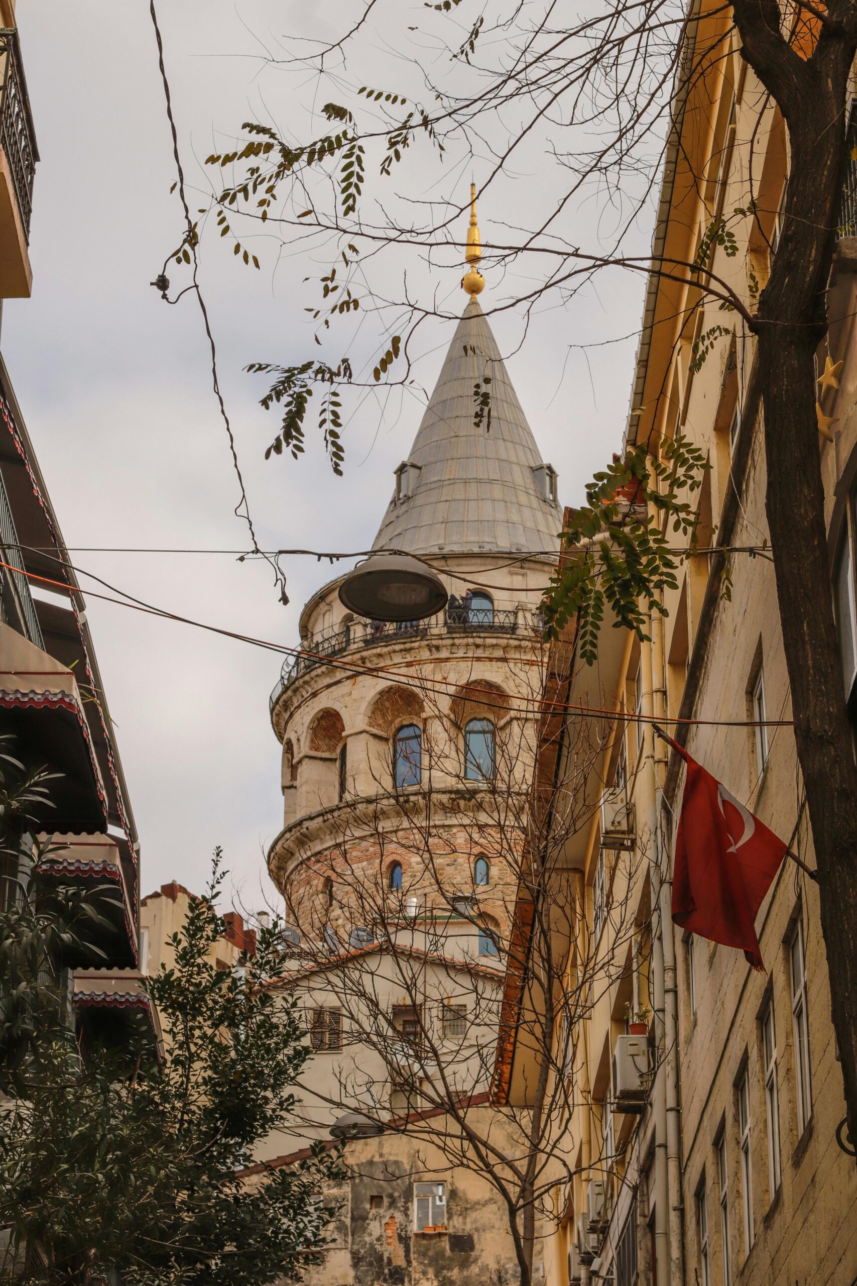 A vertical view of the iconic Galata Tower amidst Istanbul's urban architecture.